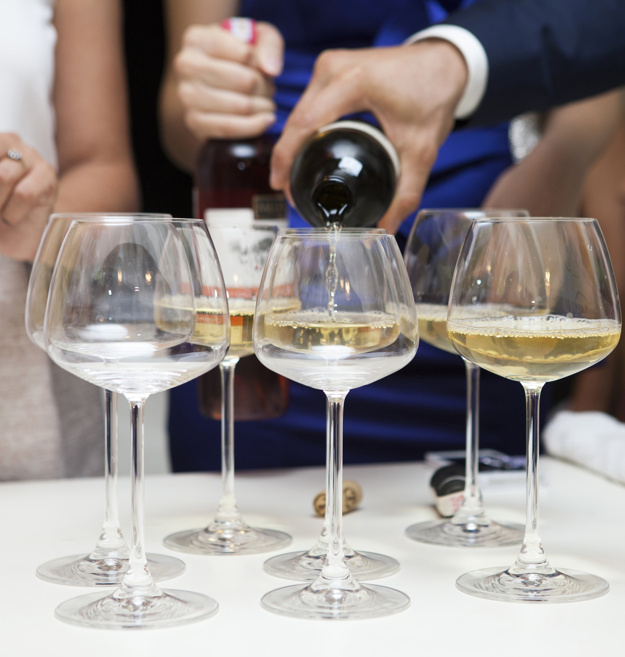 close up of man pouring white wine 1122 705