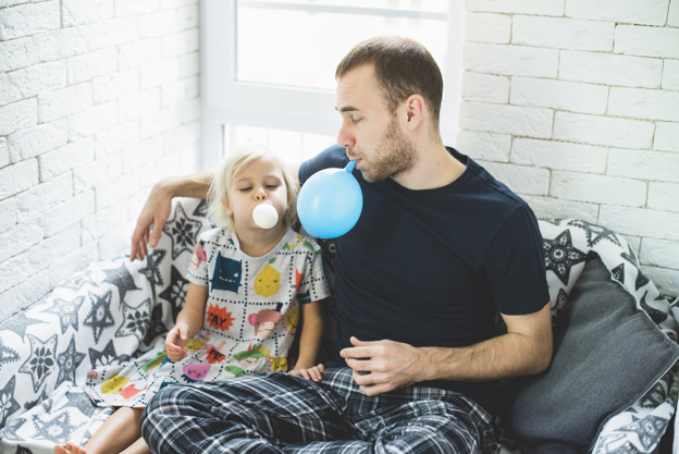 father inflating balloons with his daughter 23 2147615831