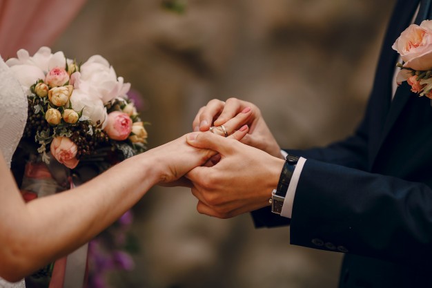 groom putting ring on bride s finger 1157 338