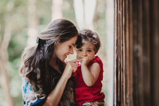 pretty little child holds mother s finger sitting on her arms 1304 3200