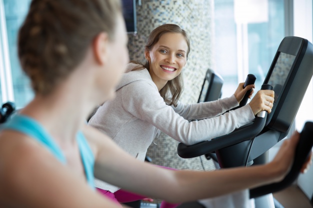 women smiling on a cardio machine 1262 714